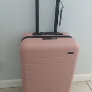 AWAY Carry-on Hardshell Spinner Suitcase (in blush pink)